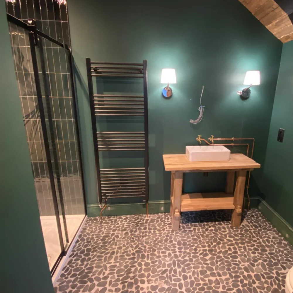 Loft conversion bathroom with dark green walls, walk in shower, vanity unit and patterned flooring by Image Home Improvements