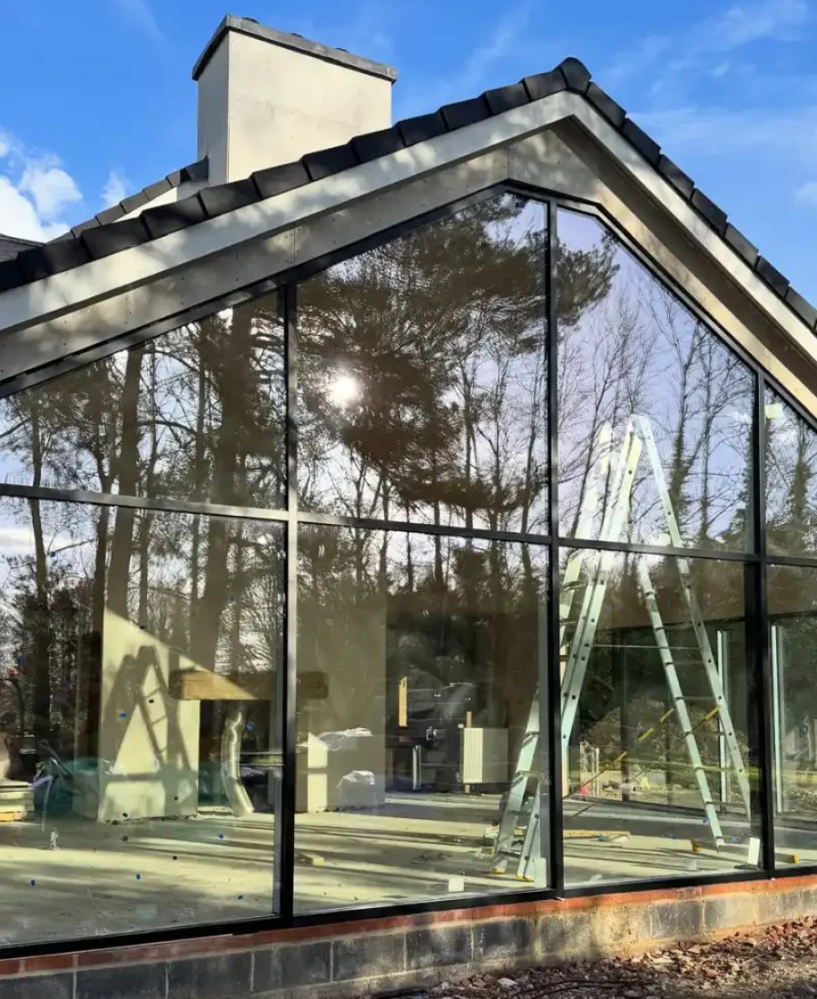 Modern home extension with floor to ceiling glass glazing and black aluminium frames by Image Home Improvements